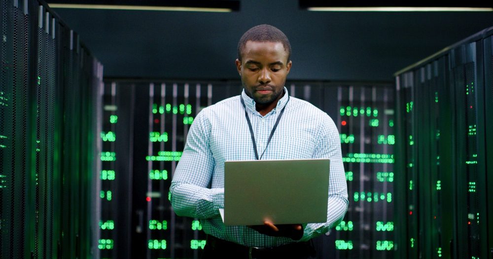 Man with laptop in data center