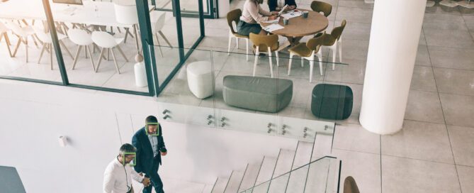 Office setting with two sets of two employees